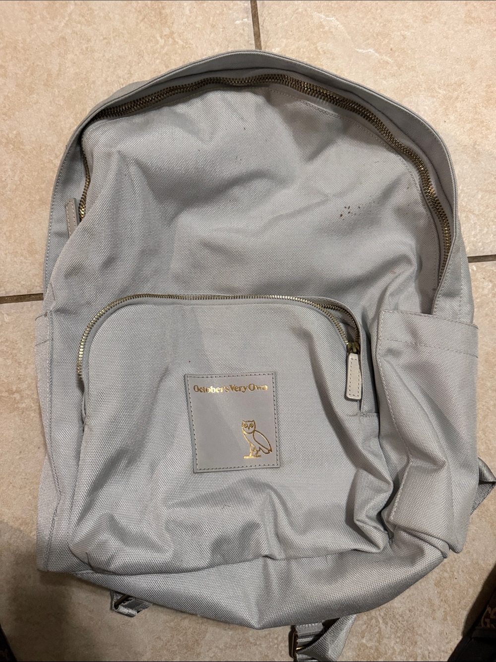 October's Very Own Light Gray Canvas Backpack with Gold Trim